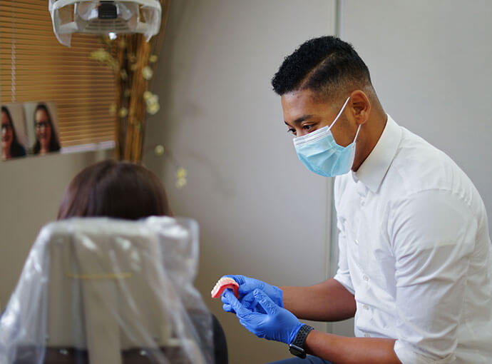 Denturist Josh Williams talking to a patient