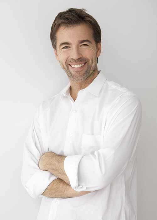 A man with a white shirt smiling